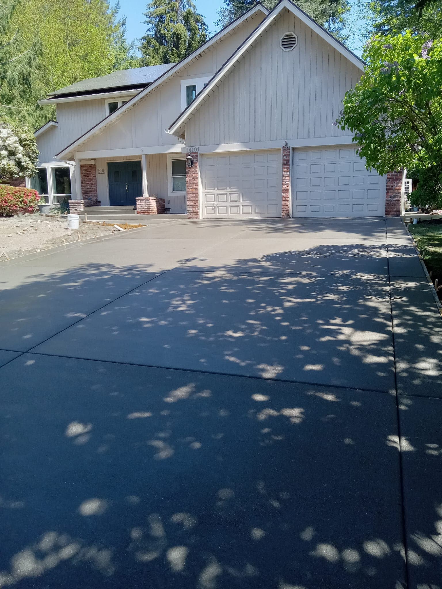 Clean finished concrete driveway leading to residential home