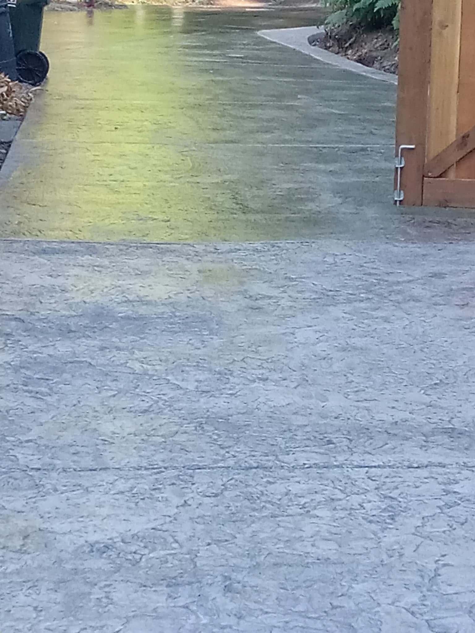 Stamped concrete entry pathway with cedar gate and garden border